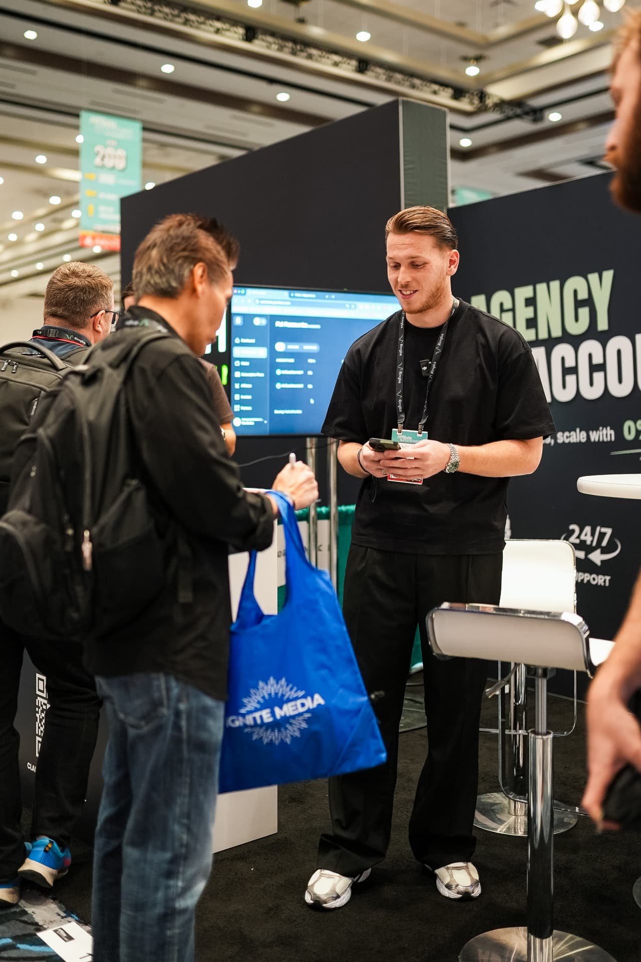 Ad Guardians team member demoing the dashboard to visitors at the booth